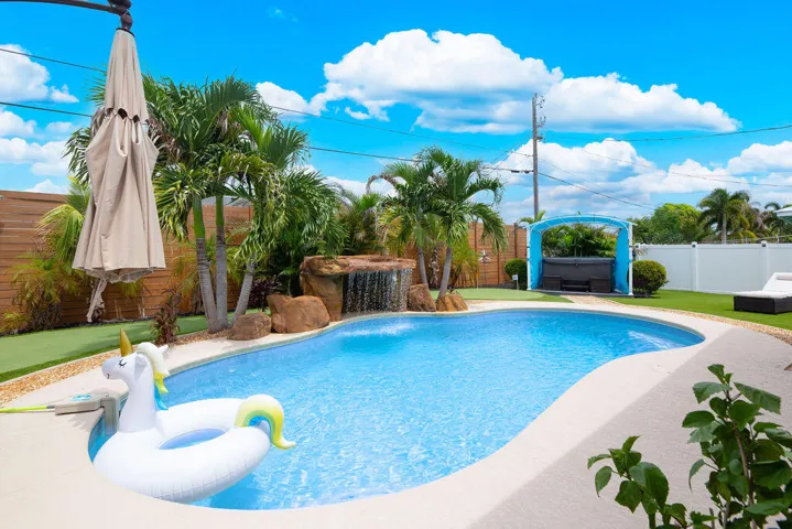 Heated pool with waterfall and lounge space
