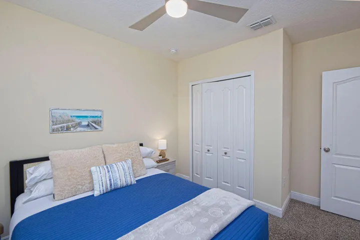 Recessed lighting, ceiling fan, bi-fold closet doors, textured carpeting, and a paneled interior door