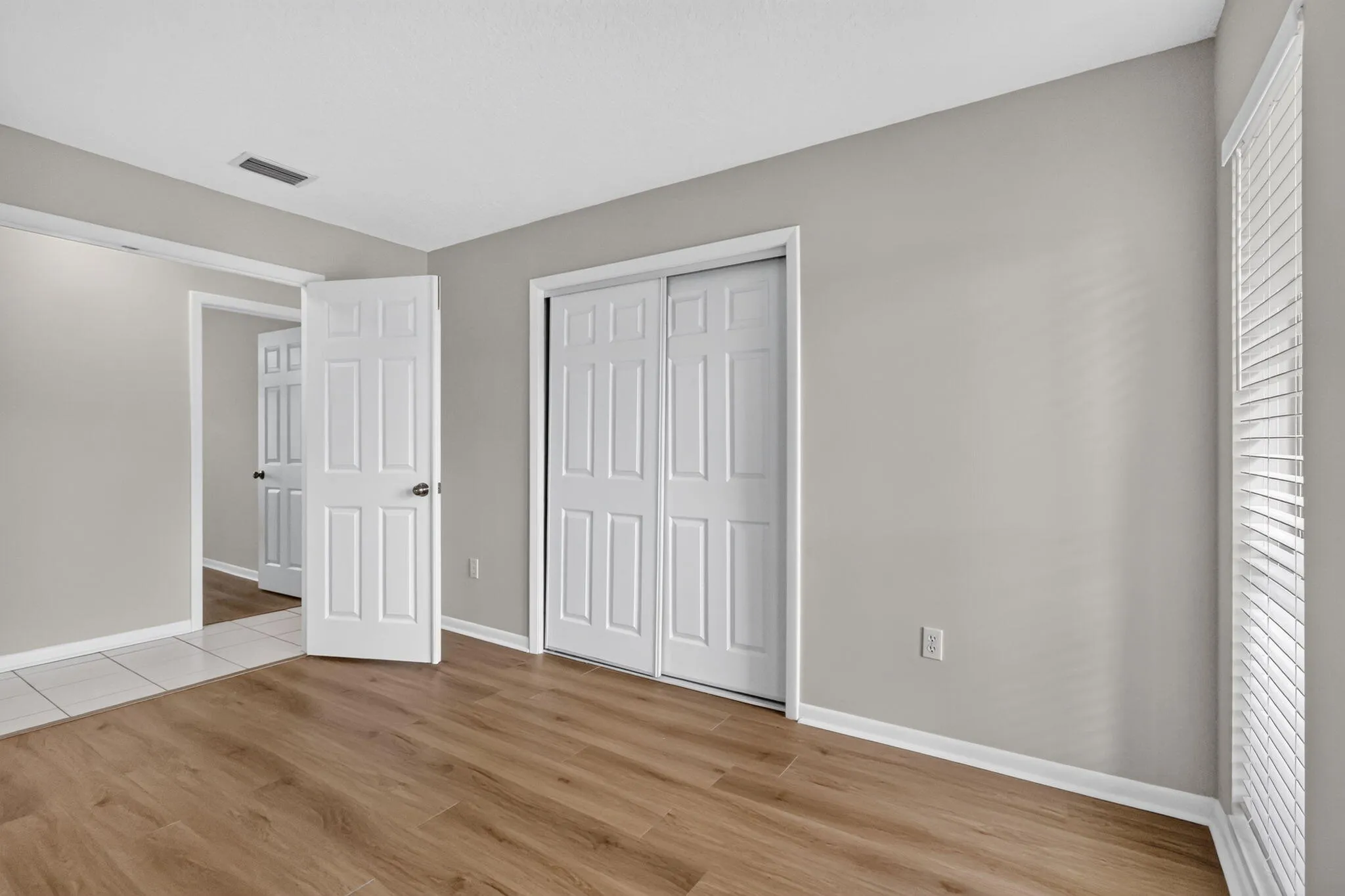Wood-finish flooring with white baseboards
