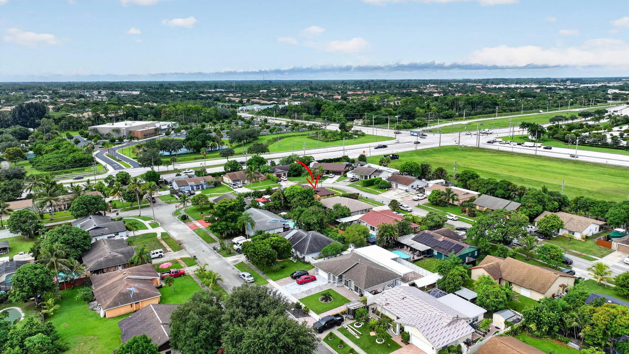 Residential neighborhood setting with established landscaping and paved roadways