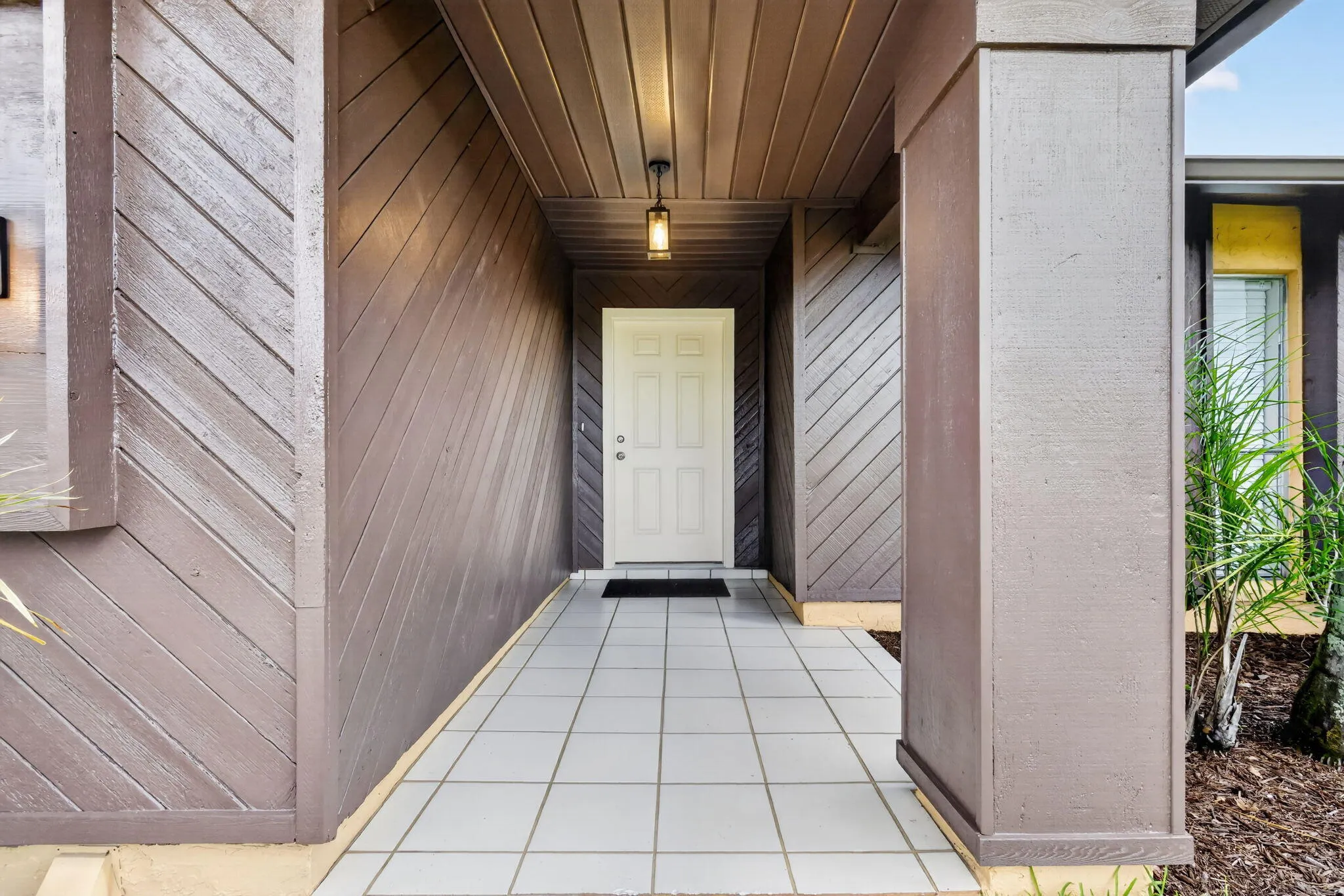 Covered entryway with tile flooring and a paneled ceiling