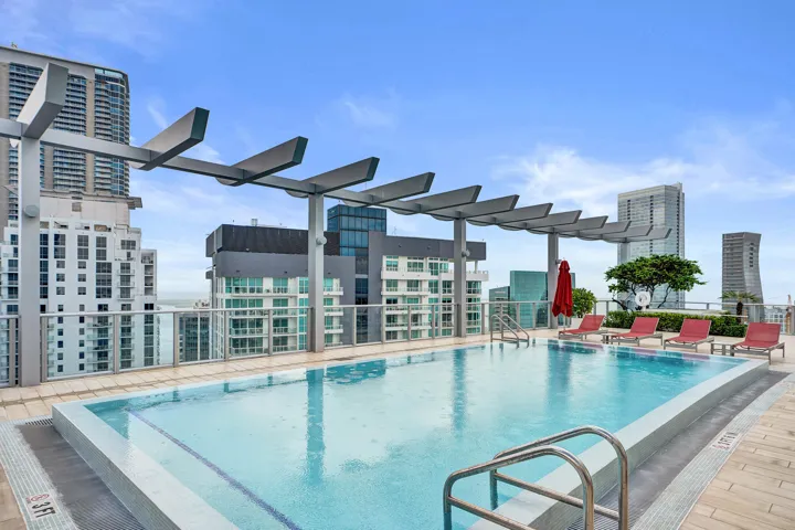 Rooftop swimming pool with a metal pergola structure