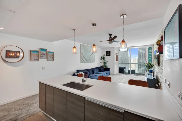 Kitchen island with integrated sink, quartz countertop, and wood-finish cabinetry