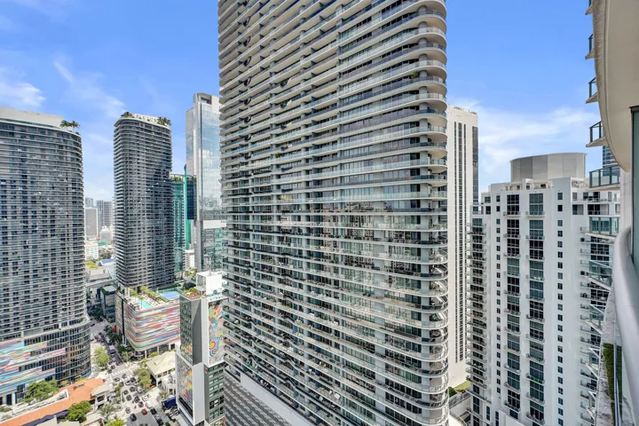 High-rise urban setting with multiple residential towers, city infrastructure, and contemporary building facades