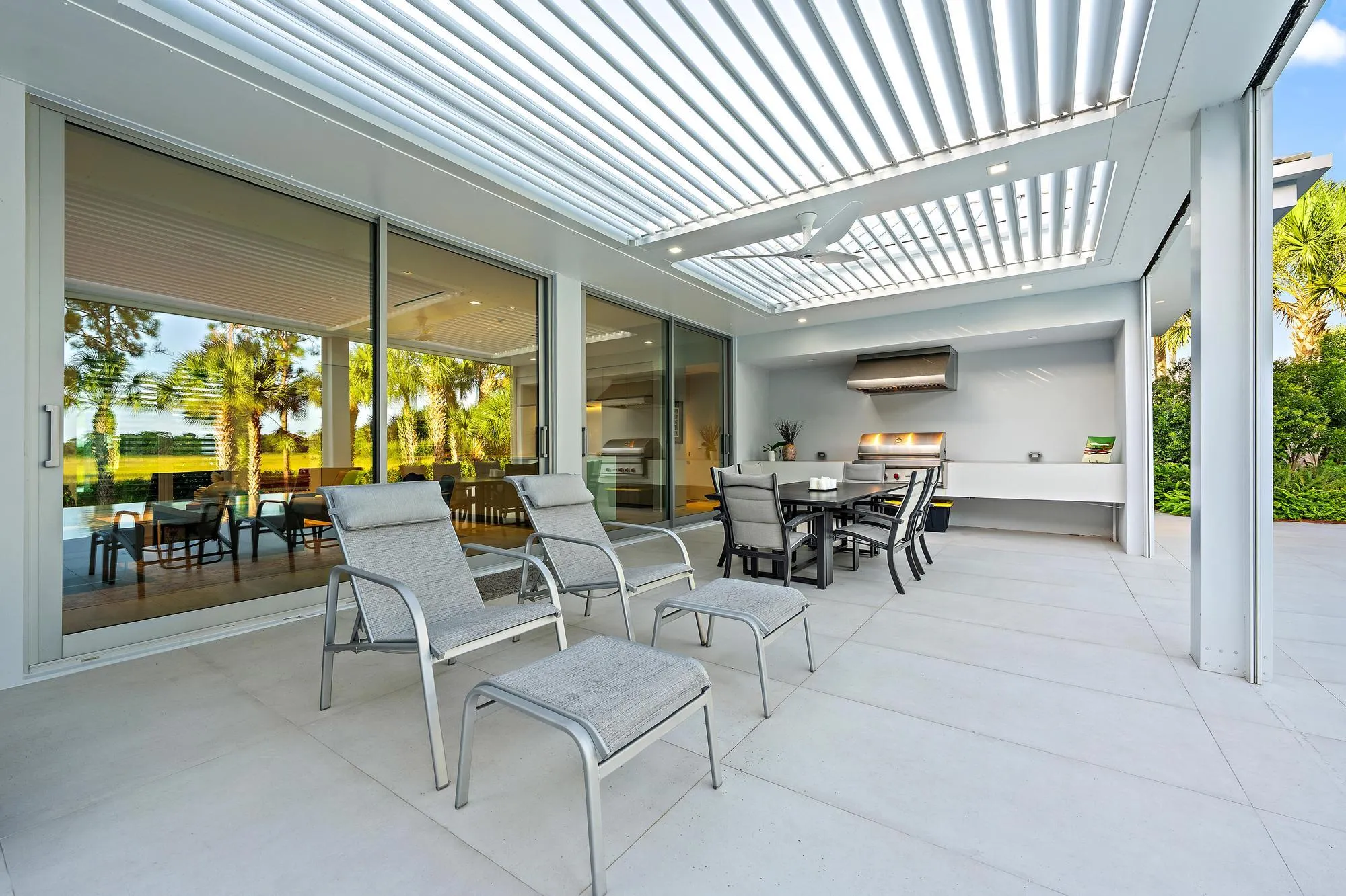 Expansive outdoor living area featuring a louvered patio cover, integrated ceiling fan, and recessed lighting