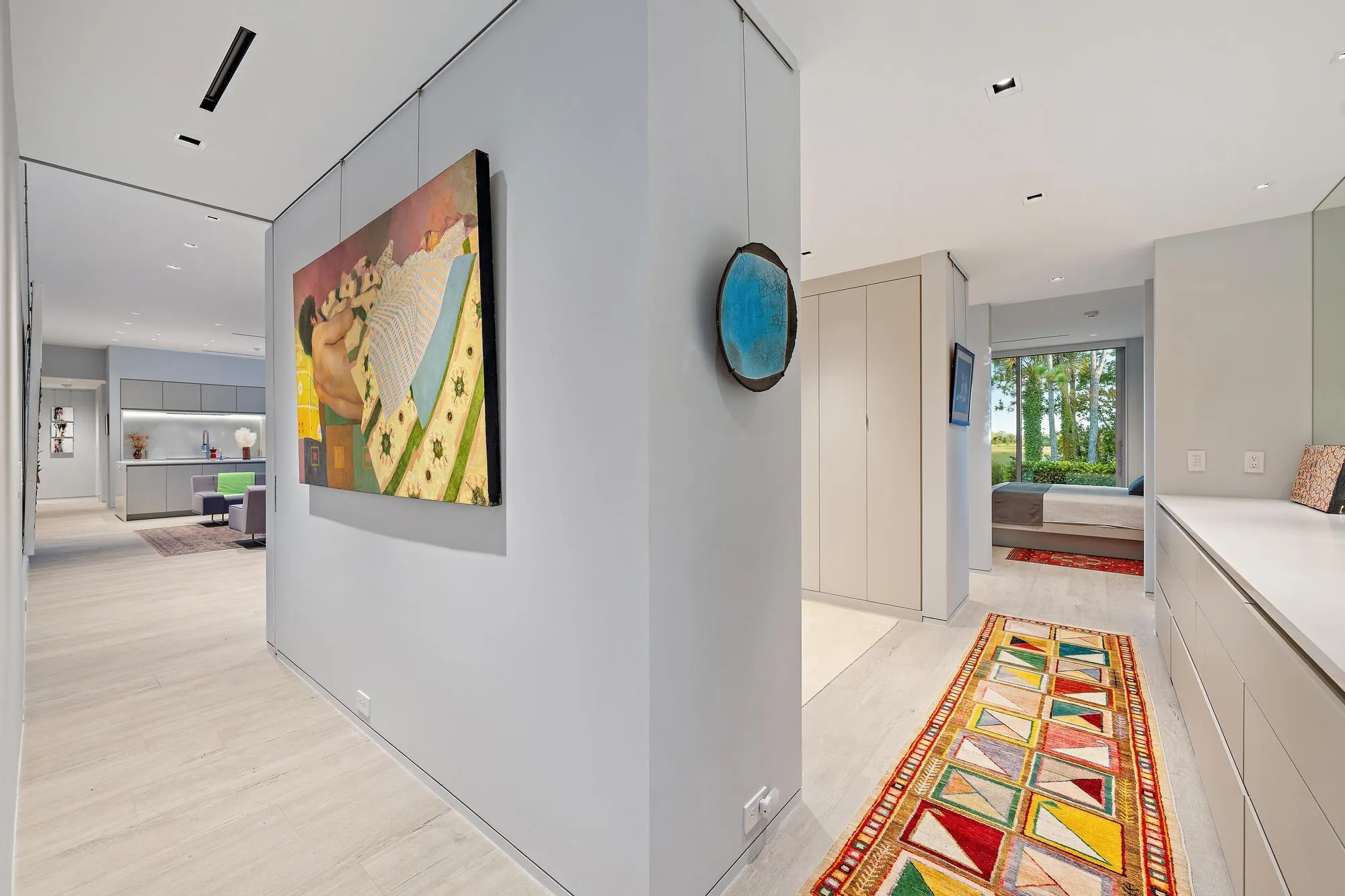 Recessed lighting, wood-finish flooring, built-in cabinetry, and a large window