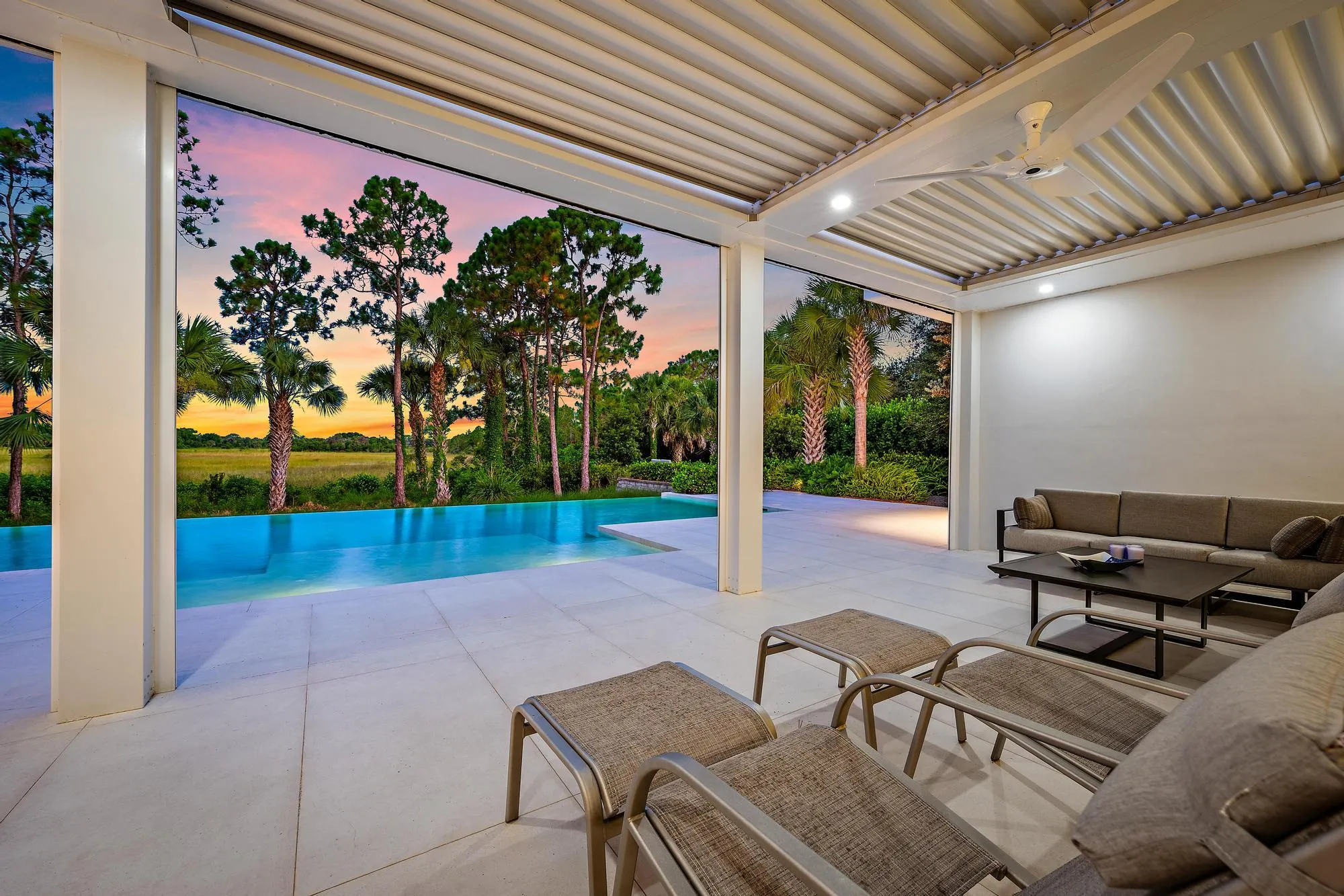 Covered outdoor patio with a corrugated ceiling, recessed lighting, and an integrated ceiling fan