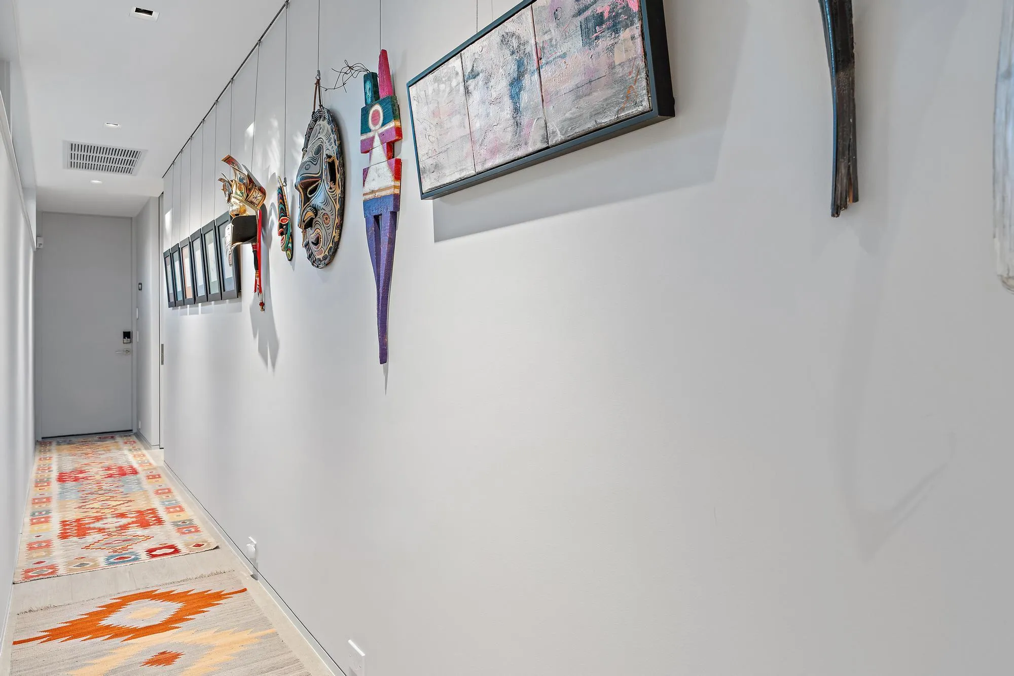 Recessed ceiling lighting, light gray wall finishes, and a light-colored wood-finish floor