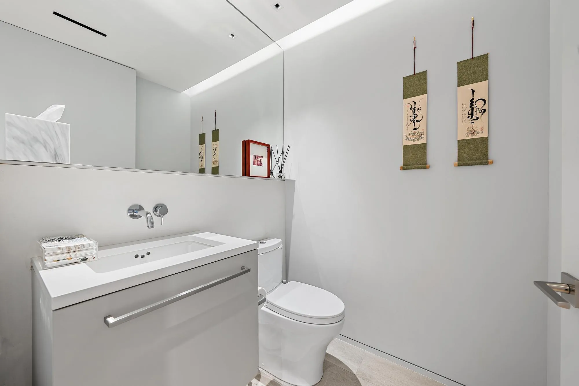 Wall-mounted faucet over an integrated sink and countertop