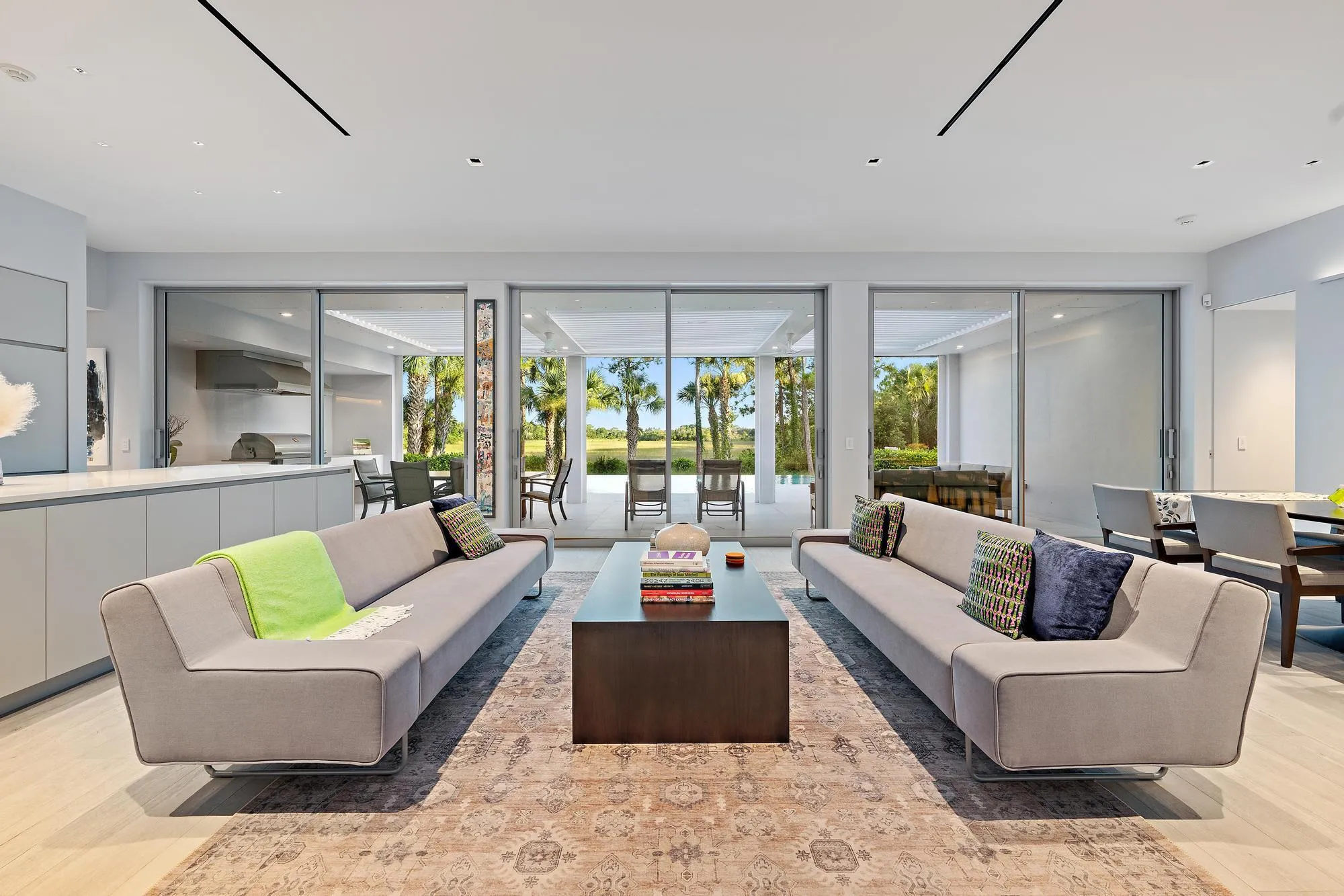 Expansive living area with light-toned wood-finish flooring