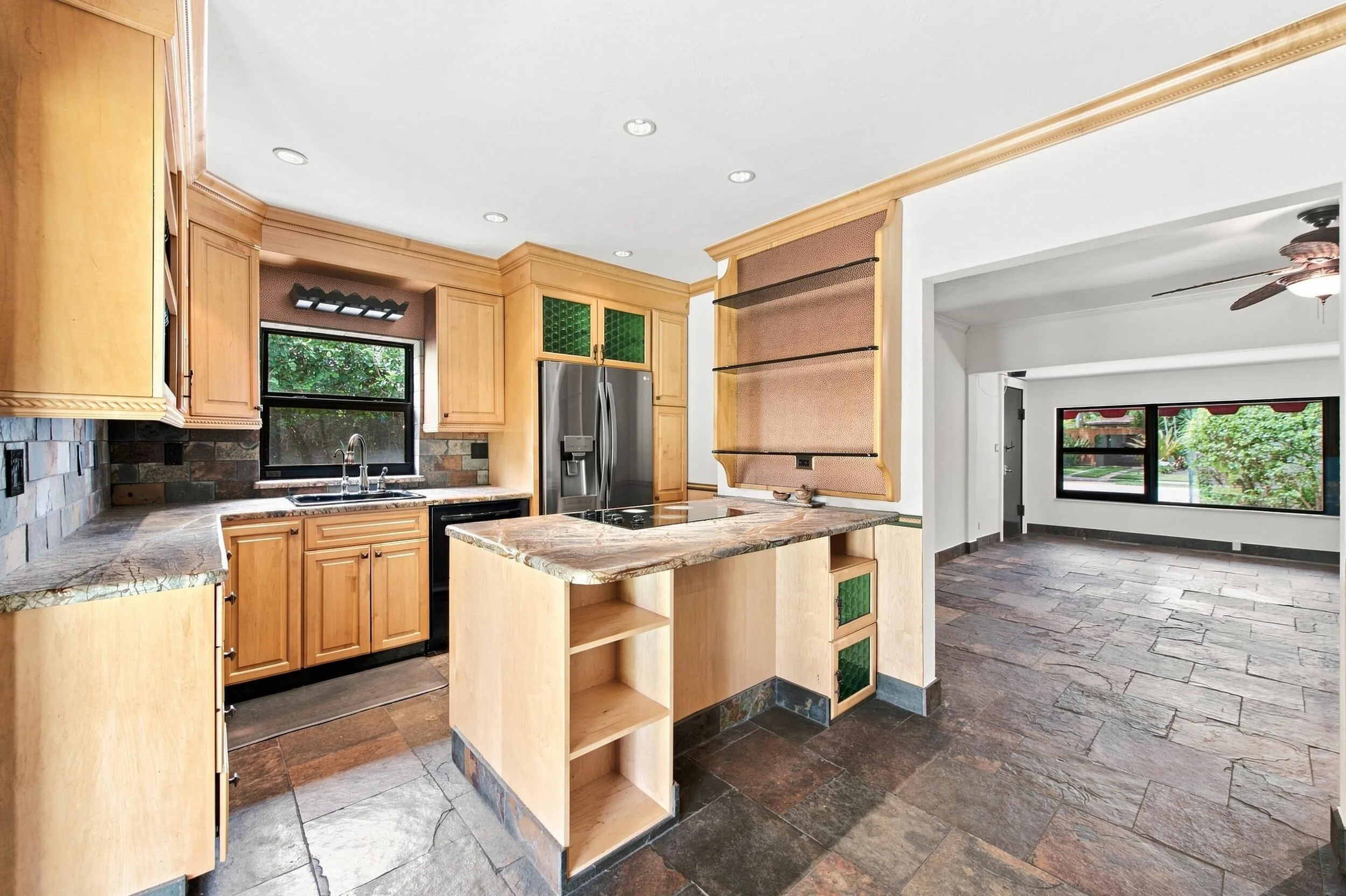 Kitchen featuring light wood cabinetry, stone-finish countertops, stainless steel refrigerator, and recessed lighting