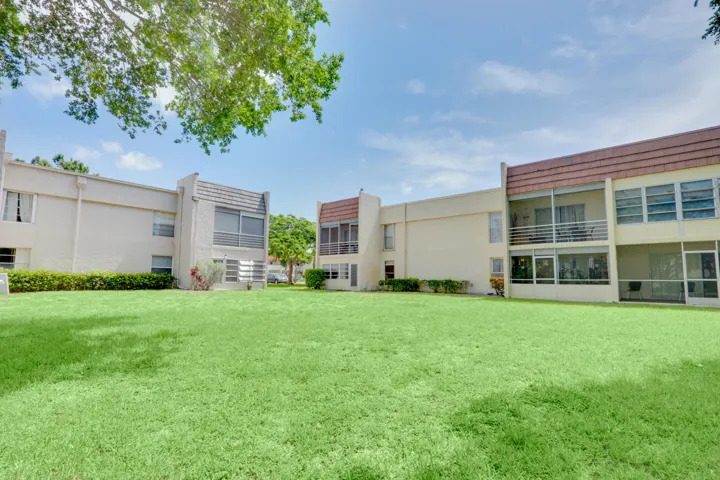 Well-maintained community courtyard with expansive green space and mature landscaping.