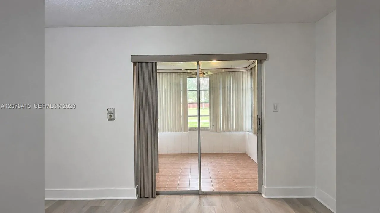 Sliding Glass Door to Enclosed Porch Digitally Decluttered