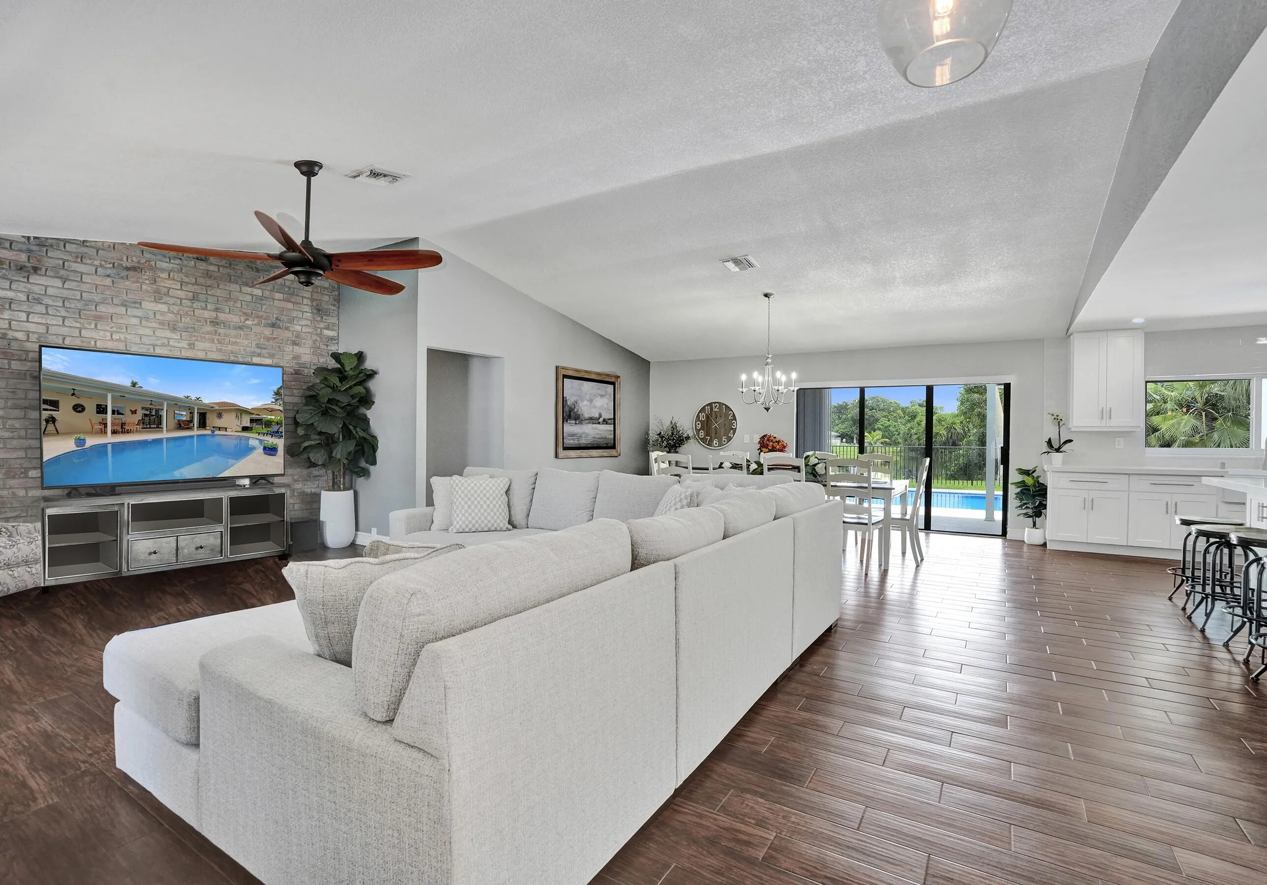 View from front door- living room, dining, kitchen and pool
