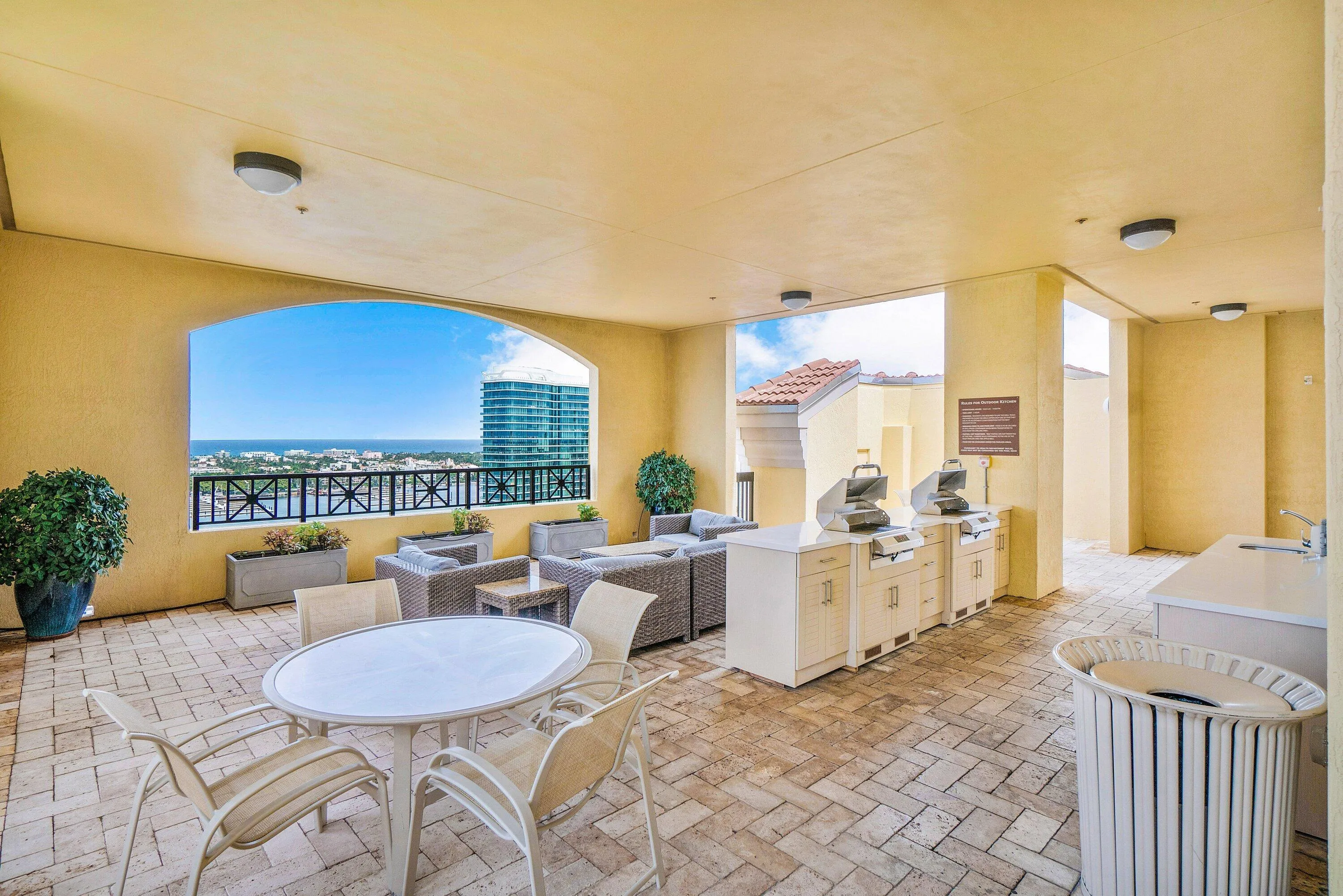 Large covered patio featuring a built-in outdoor kitchen with grills, and generous lounge area