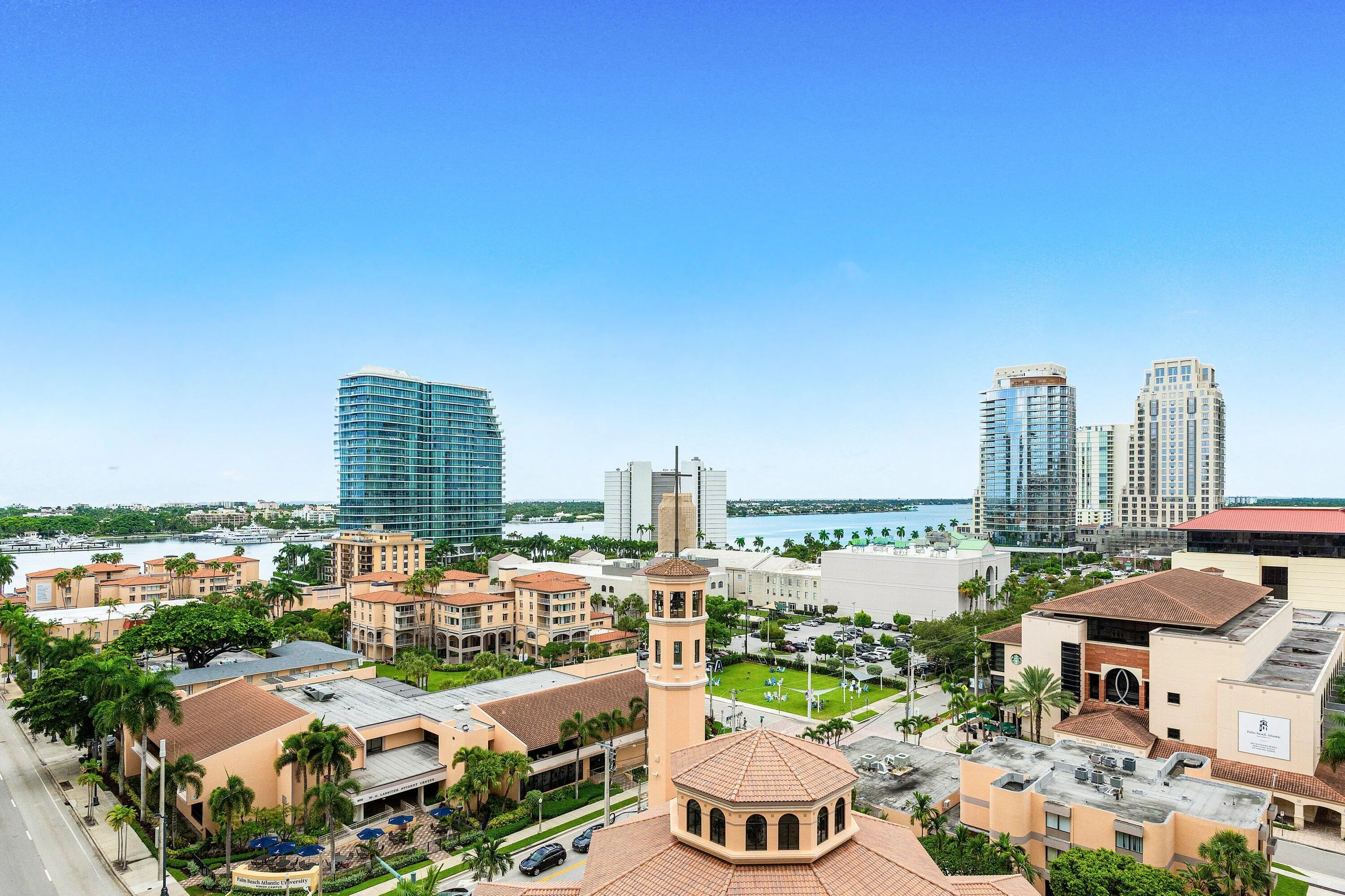 Expansive cityscape with architecturally diverse buildings and the Intracoastal Waterway.