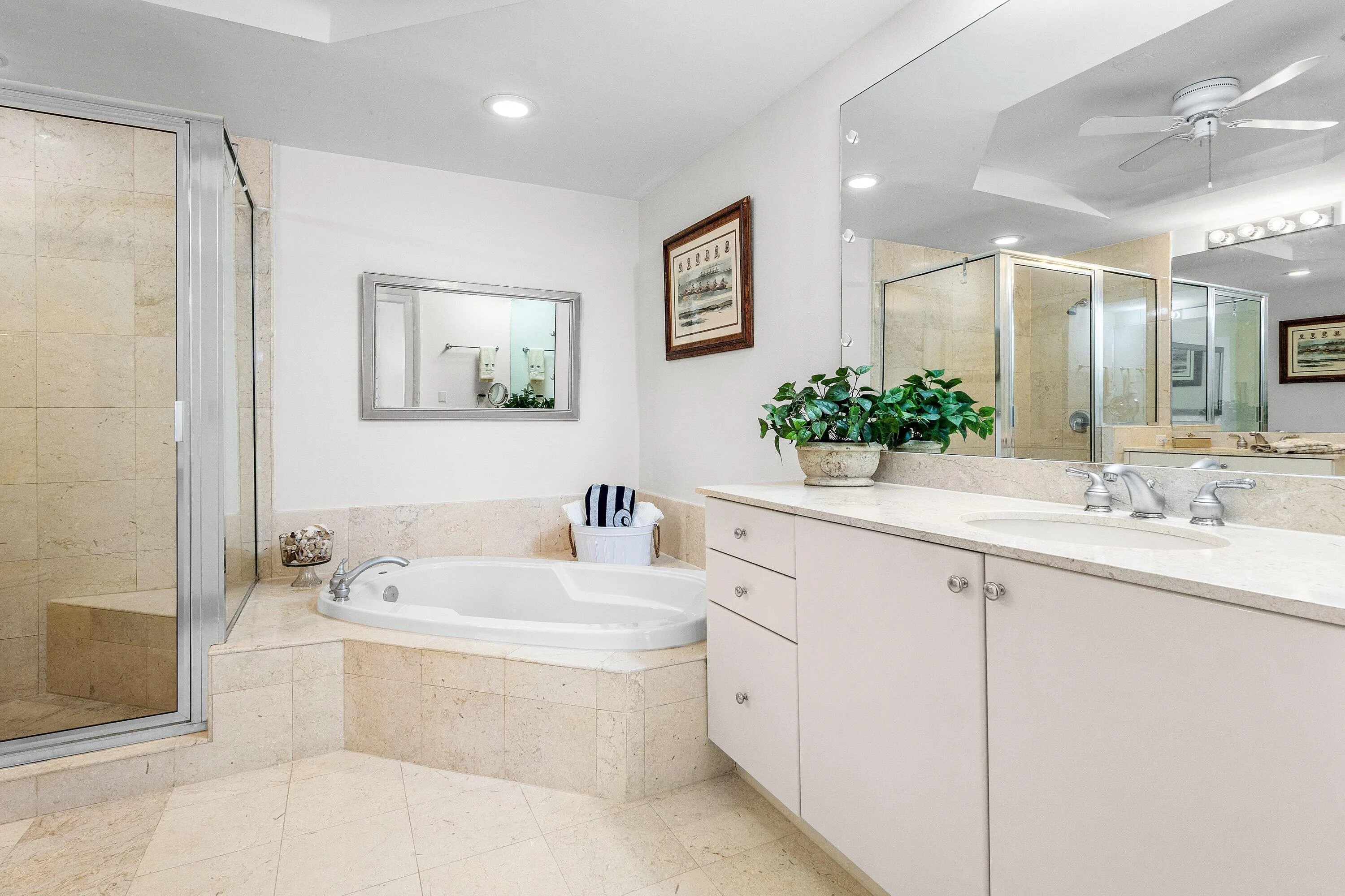 Double Sinks, glass enclosed shower with sitting bench