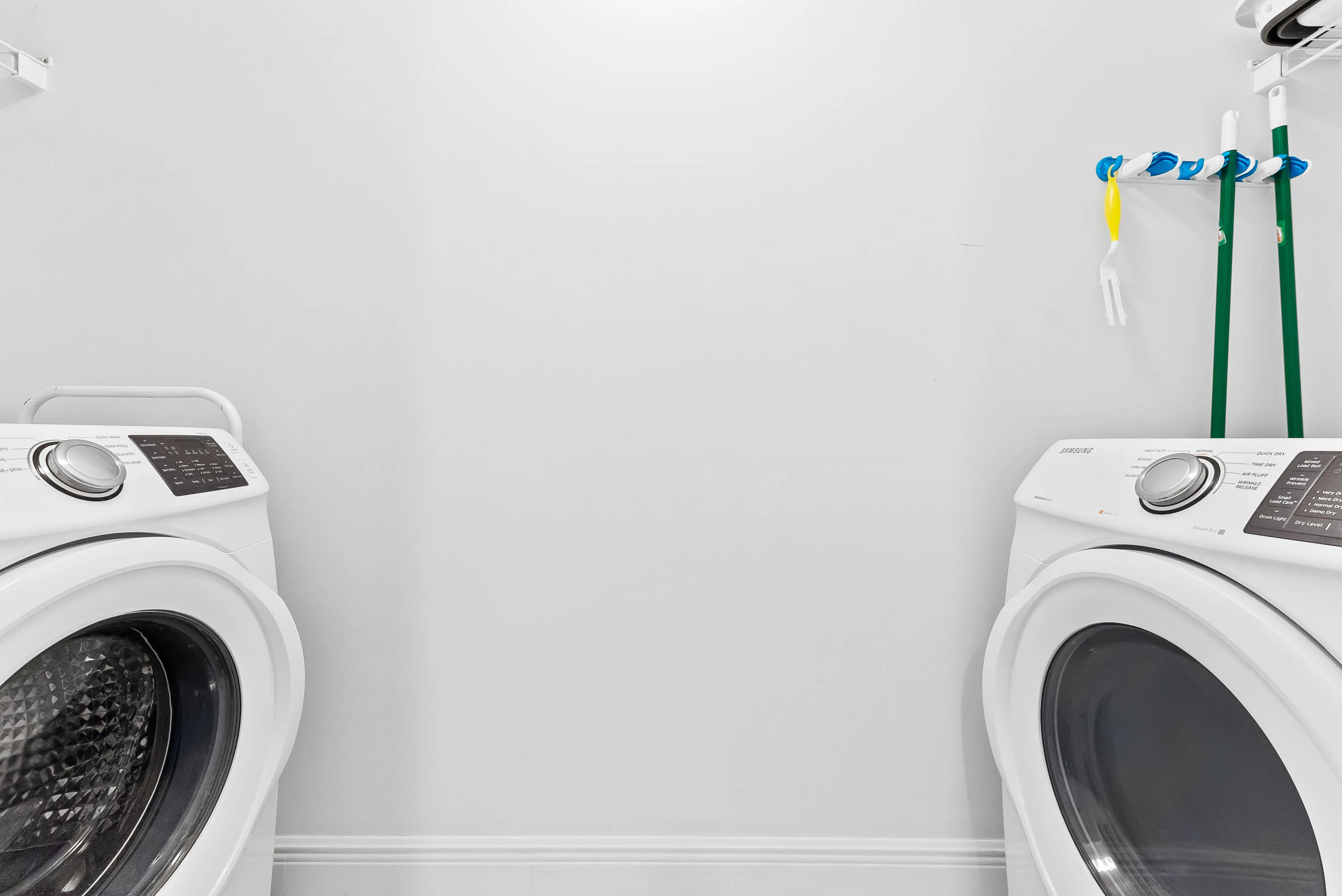 Laundry closet with full sized washer & dryer.