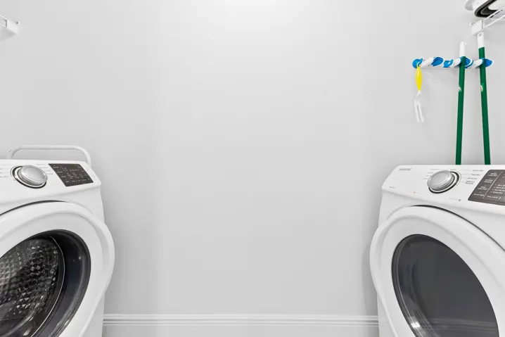 Laundry closet with full sized washer & dryer.