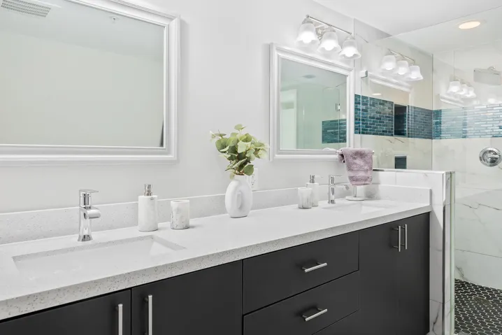 Remodeled primary bathroom with shower, dual sinks & freestanding bathtub