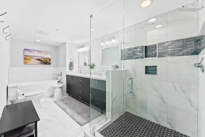 Remodeled primary bathroom with shower, dual sinks & freestanding bathtub