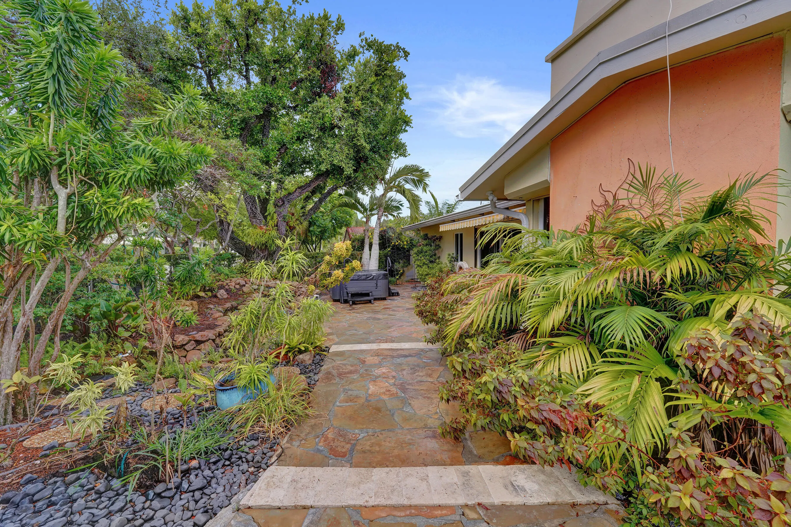 Stone pathway with varied foliage and tropical landscaping