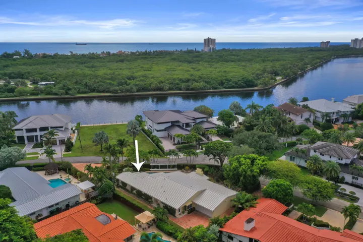 Oversized lot, lush landscaping with mature palm trees, and a spacious backyard.