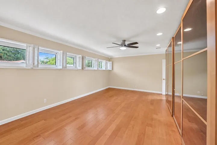 Wood-finish flooring, recessed lighting, and a ceiling fan