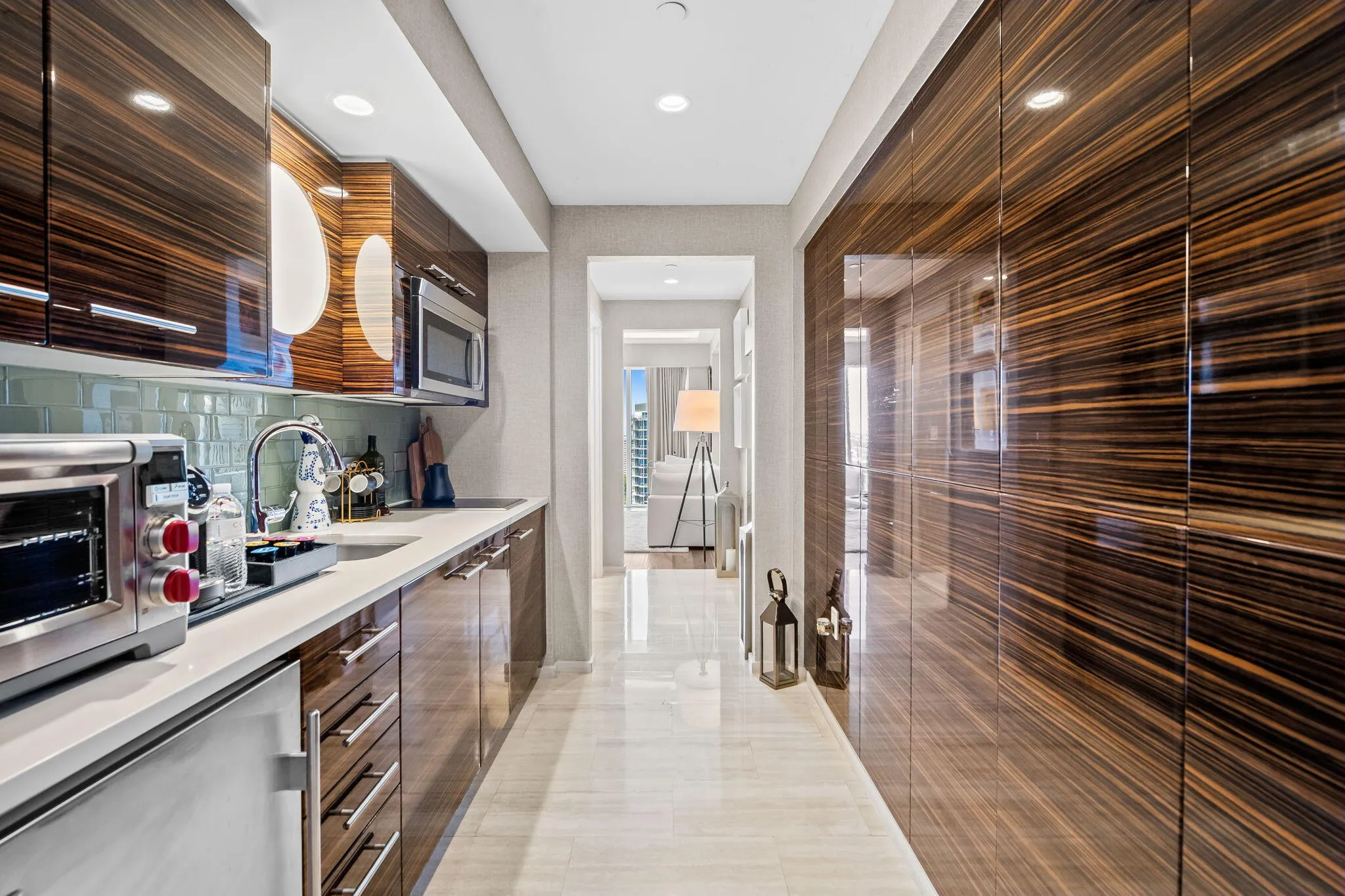Integrated kitchen cabinetry with wood-grain finish and stainless steel hardware