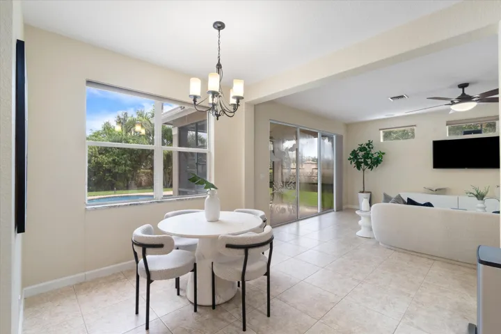 Recessed lighting, tile flooring, a chandelier, and sliding glass doors