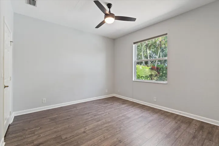 Recessed lighting, wood-finish flooring, and a ceiling fan with integrated lighting