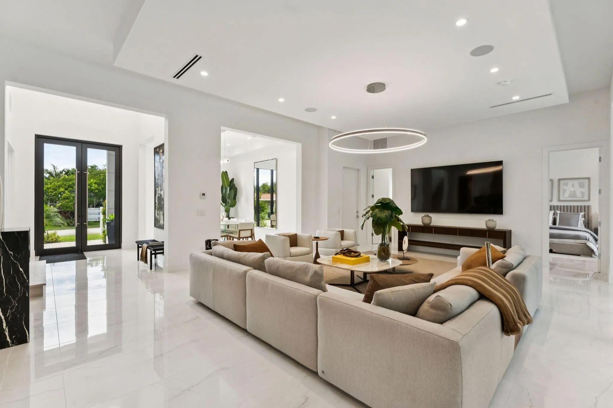 White tile flooring, recessed lighting, double entry doors, contemporary chandelier, built-in media console