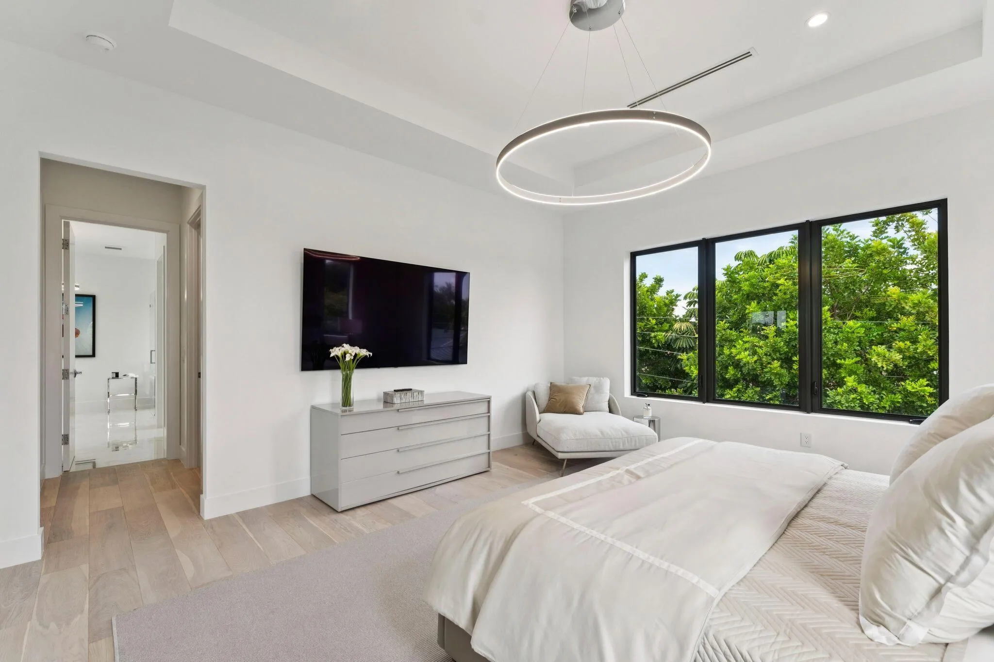 Recessed ceiling with an integrated linear light fixture and a contemporary circular pendant