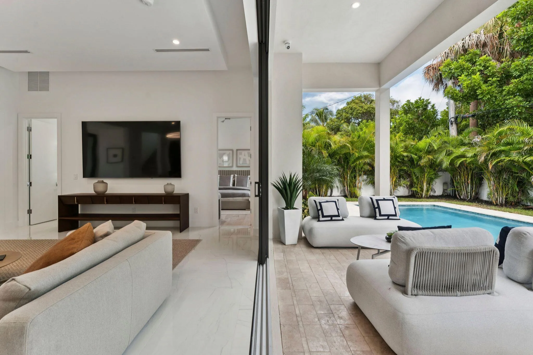 Expansive outdoor living area with covered patio and swimming pool
