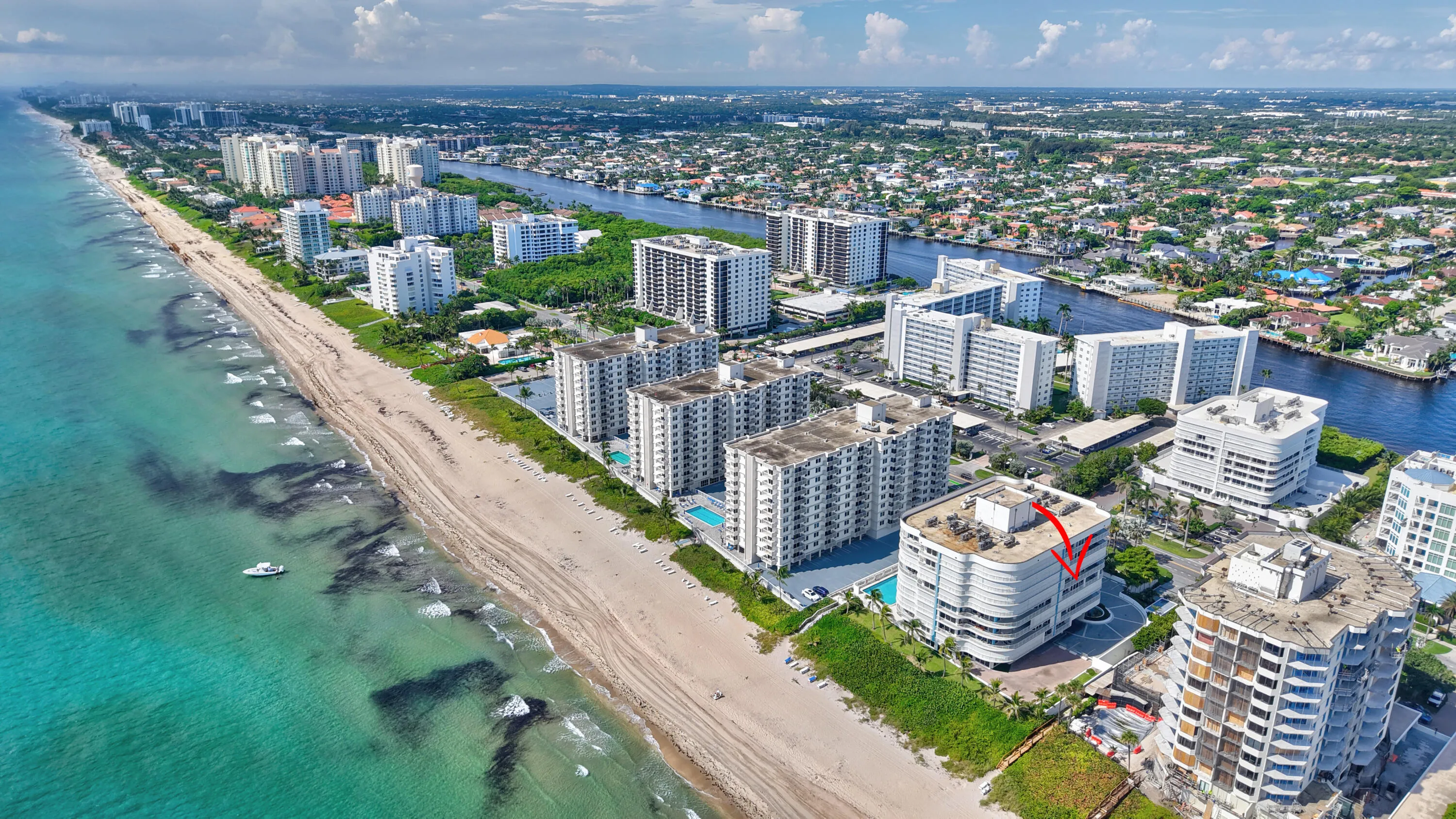 Expansive coastal setting featuring beach frontage, urban development, and a prominent waterway