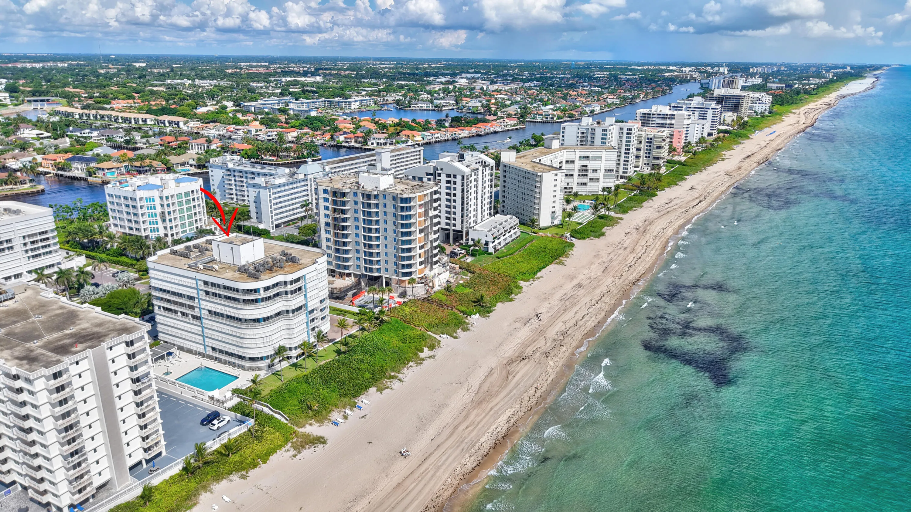 Coastal high-rise building with a private outdoor pool, direct beach access, and a water-facing orientation