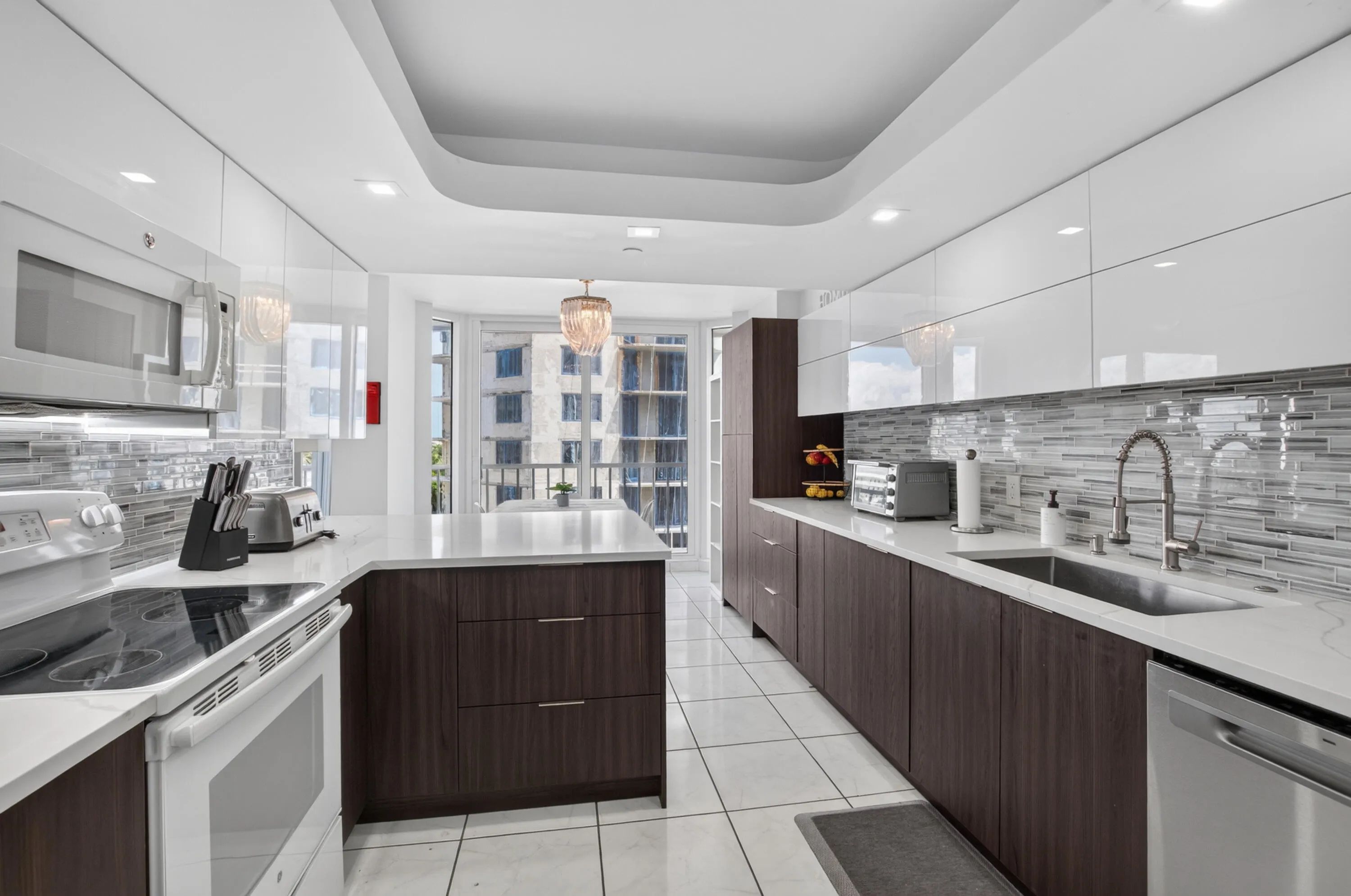 Modern kitchen featuring wood-finish lower cabinetry, white upper cabinetry, and white countertops