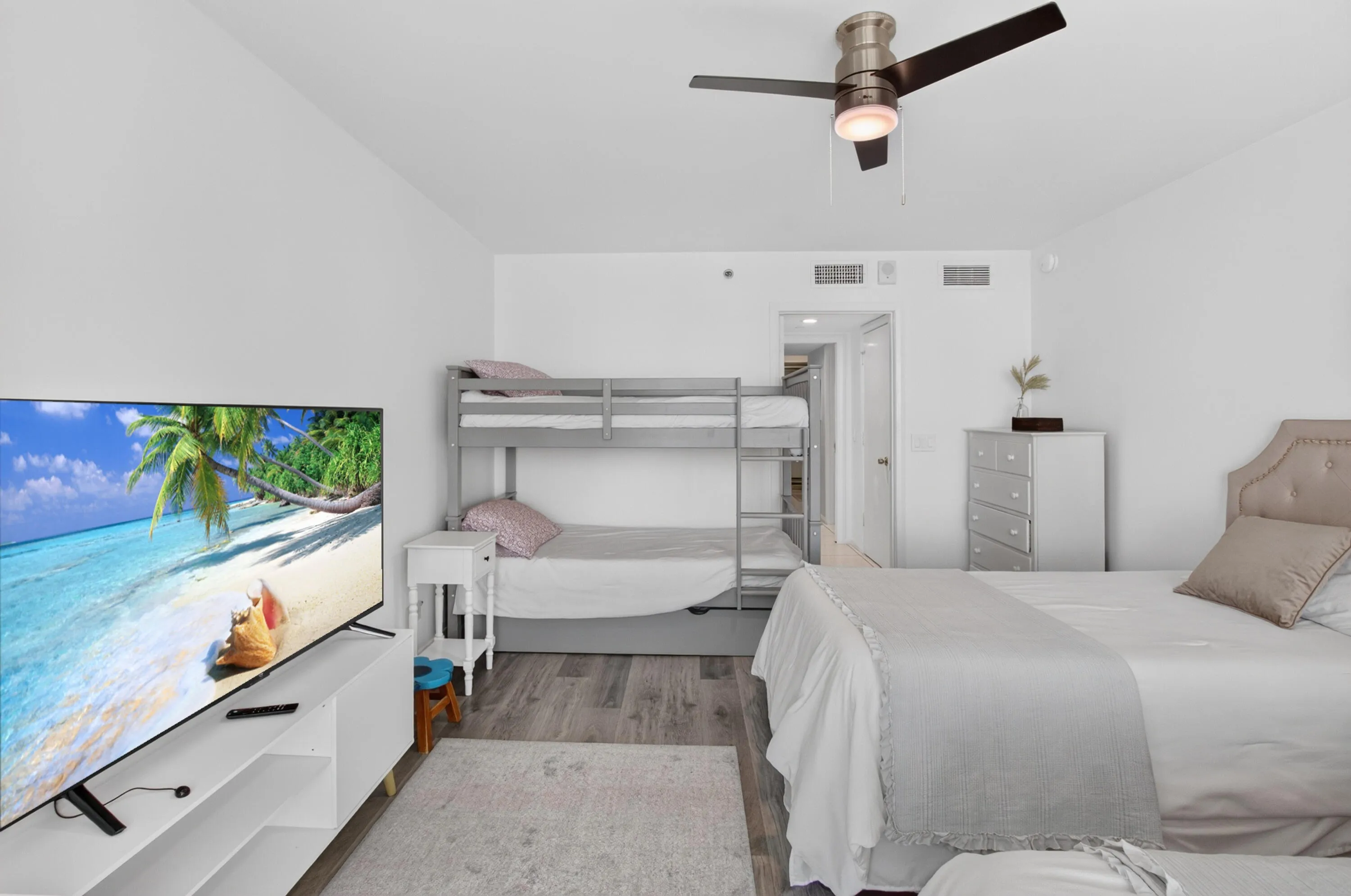 Recessed lighting, wood-finish flooring, and a ceiling fan with integrated lighting