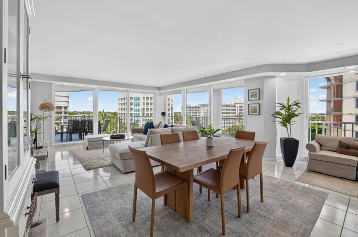 Spacious living area featuring expansive glass sliding doors, tiled flooring, recessed lighting, and a built-in display cabinet