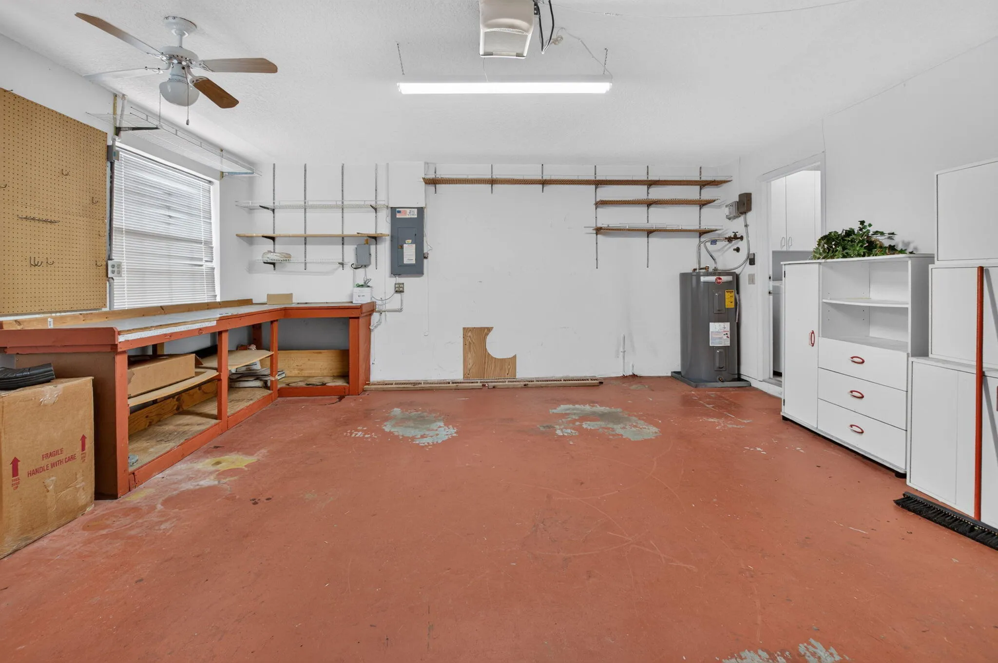 2 Car Garage with two windows shelves & cabinets