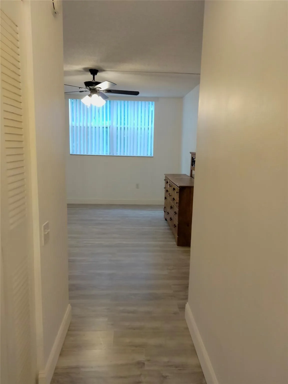 Light wood-finish flooring extending into the room