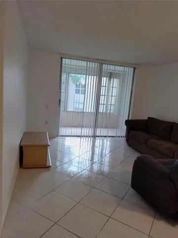 White tile flooring, sliding glass doors, vertical blinds, white walls, smooth ceilings