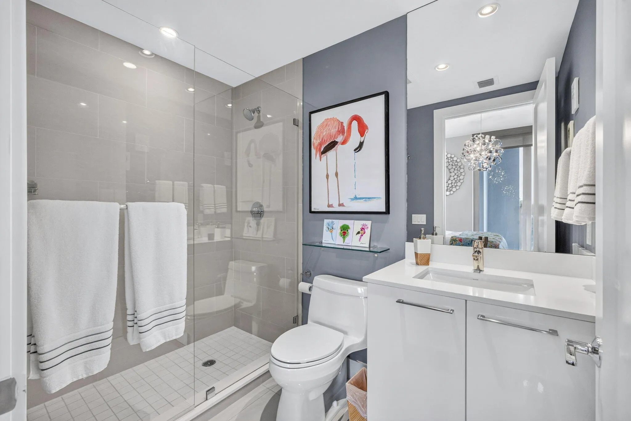 Glass-enclosed shower with tiled walls and floor