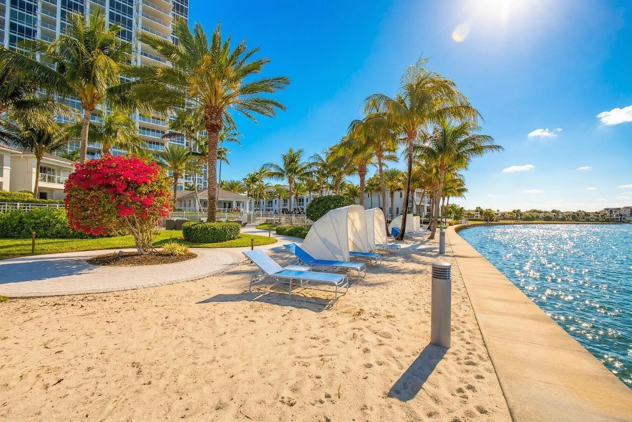 Sandy shoreline with palm trees, a curved concrete walkway inviting you to bring out your beach towel and a good book and watch the yachts go by... enjoy this "chapter" of your own biography : )