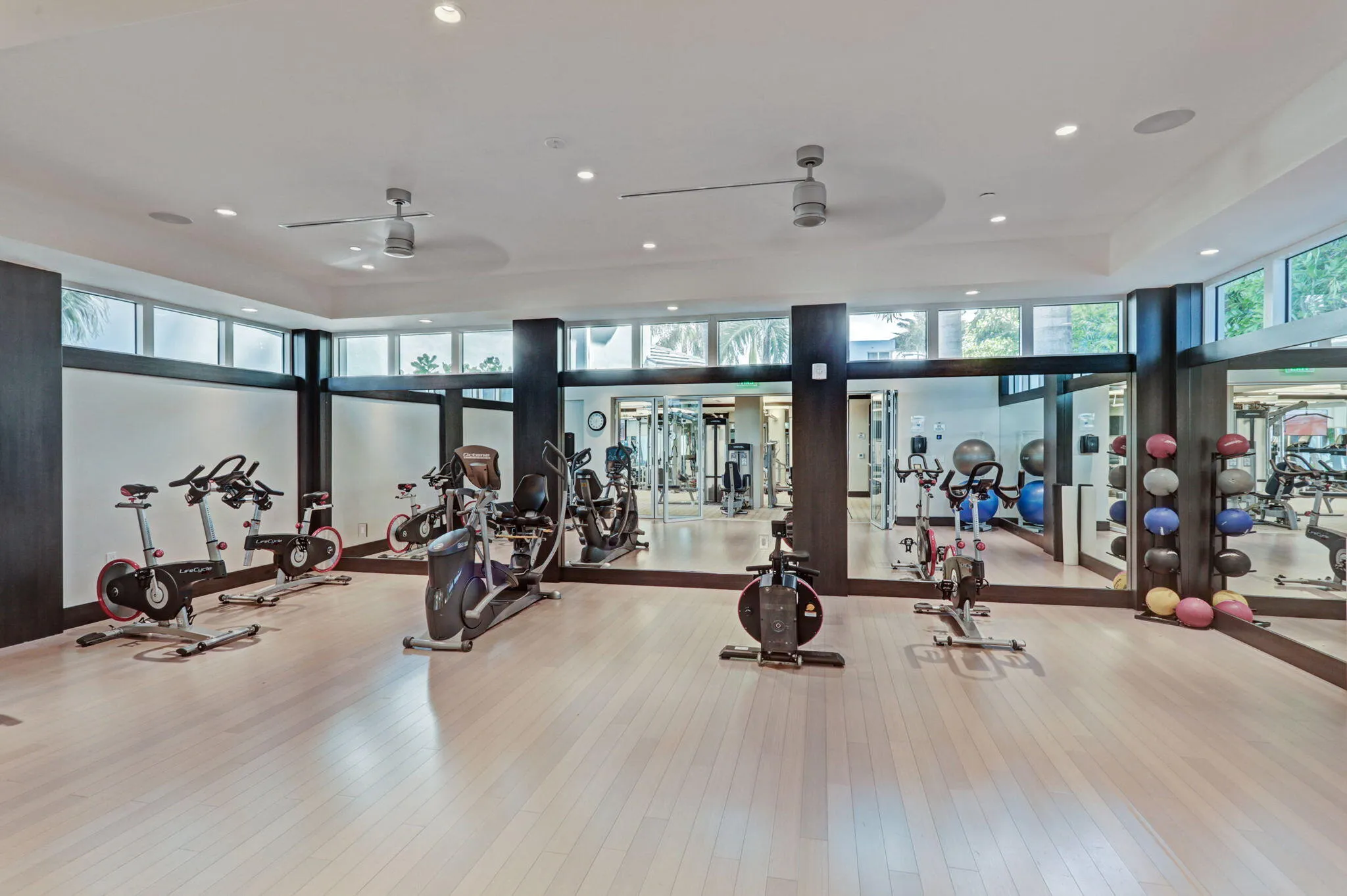 Recessed lighting, light wood-finish flooring, full-wall mirrors, and a lots of sunlight streaming in, no need to work out in a dim lit crowded gym.
