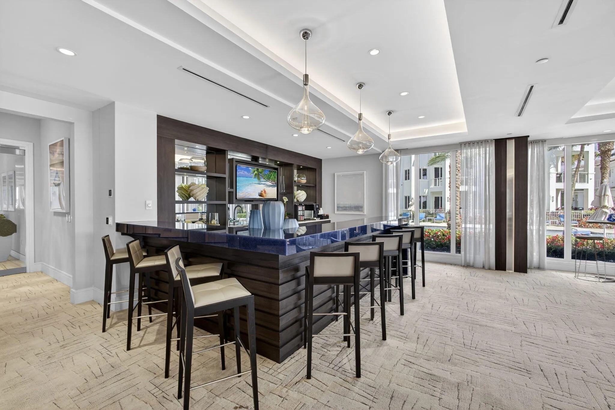 Integrated bar with dark wood-finish cabinetry, built-in shelving, and a dark countertop