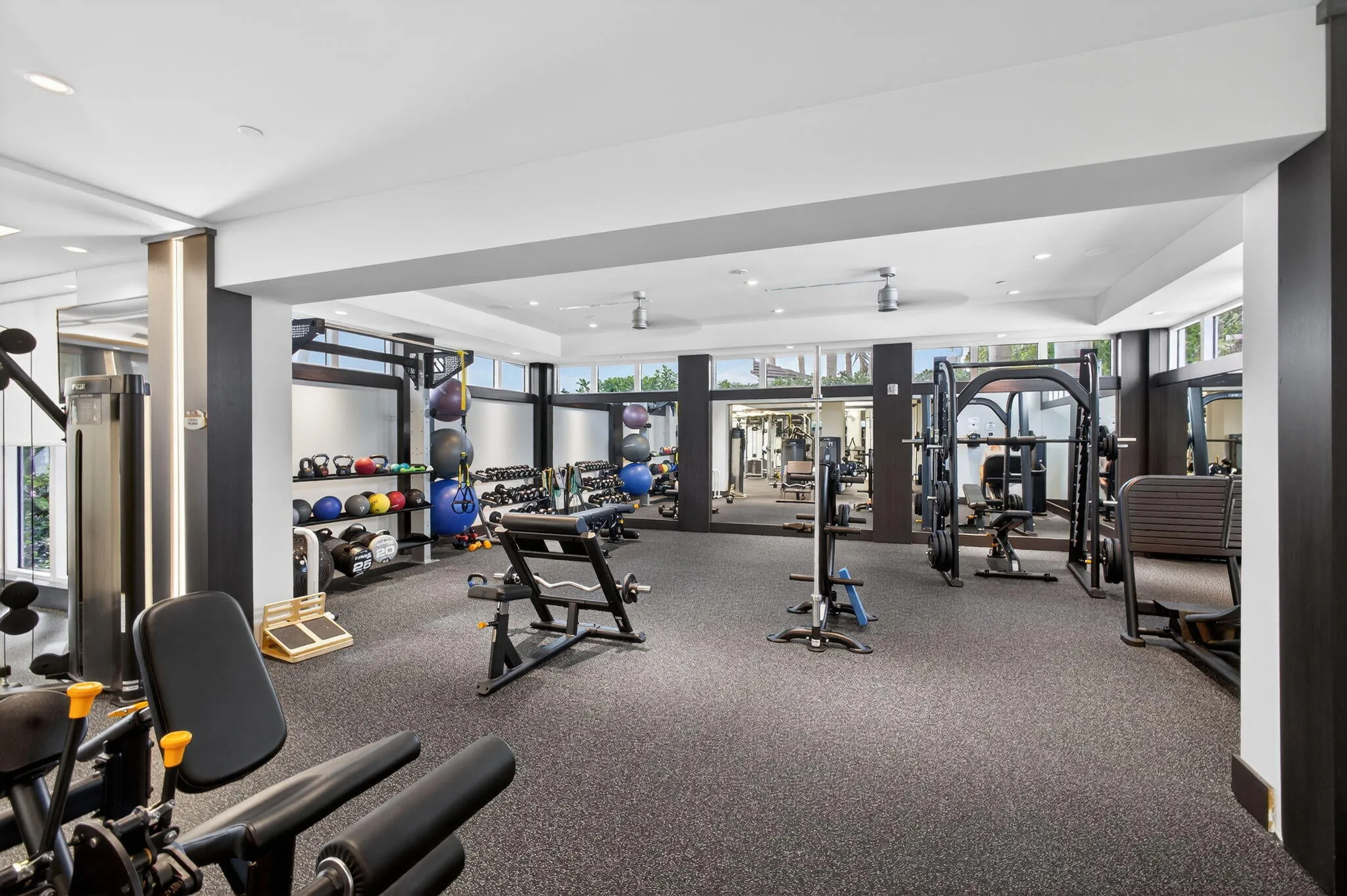 Dedicated Sunlit fitness center features recessed lighting and ceiling fans, steam room, saunas, showers , lockers and dressing areas