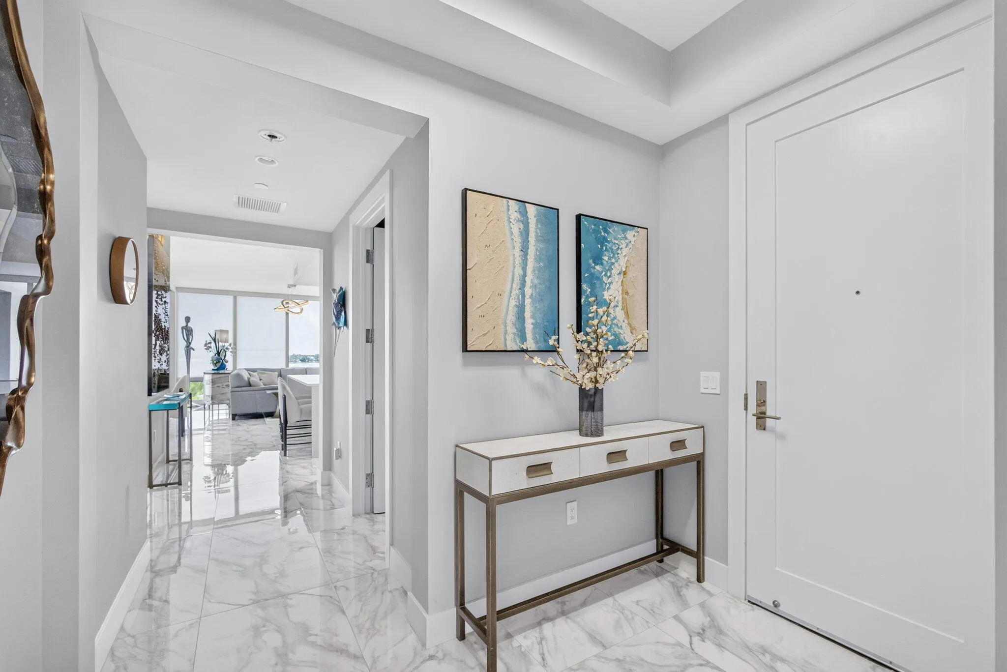 Polished marble-look flooring extending through the entry and entire home, this home has a wonderful "glow & flow" feeling!