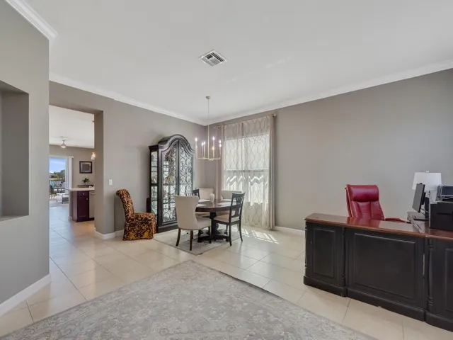 Spacious interior with tile flooring and crown molding