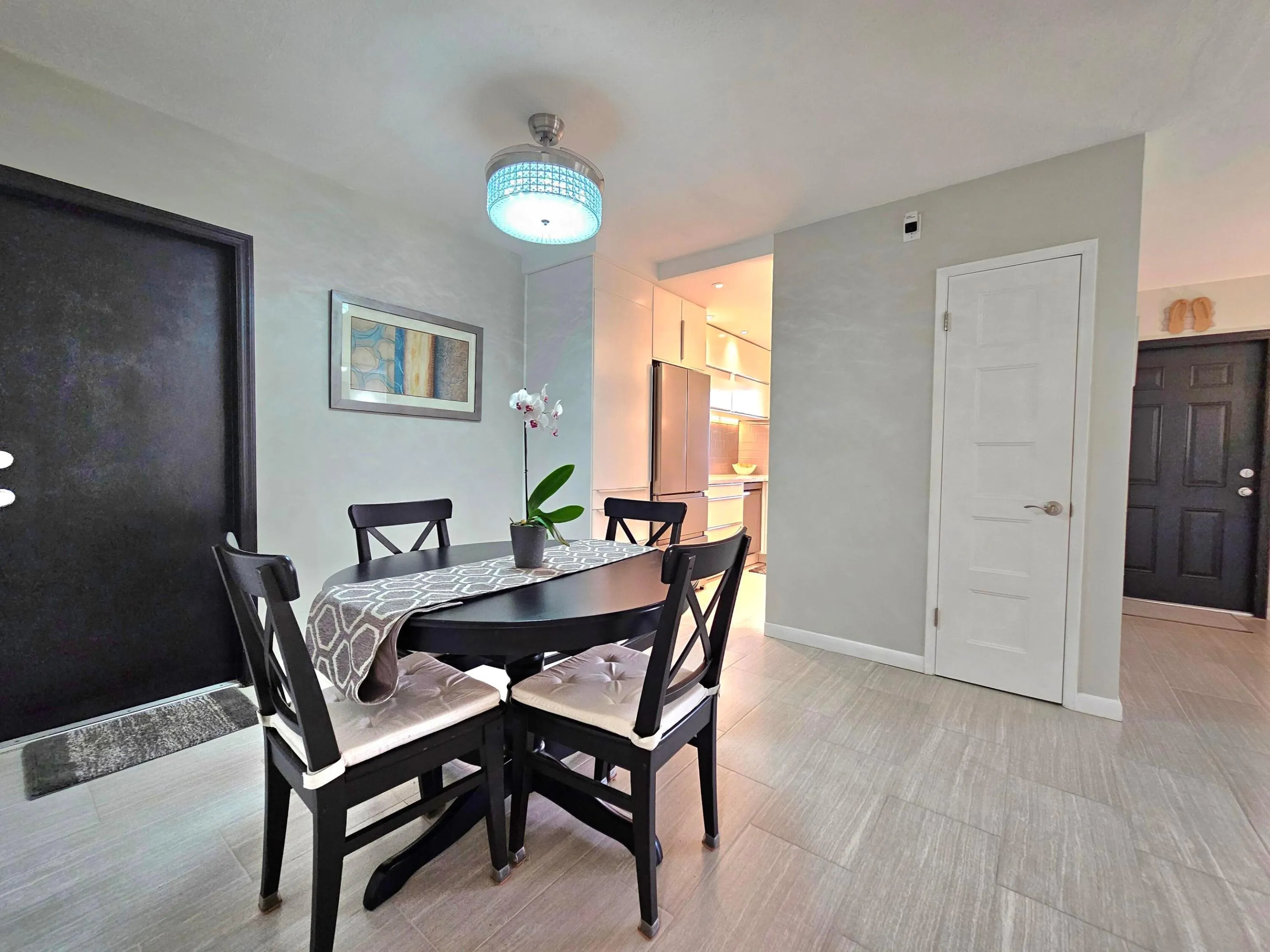 DINING ROOM SHOWING BACK DOOR TO PRIVATE PATIO AND ENTRANCE TO KITCHEN